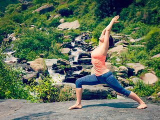 Image showing Woman doing Ashtanga Vinyasa Yoga asana Virabhadrasana 1 Warrior