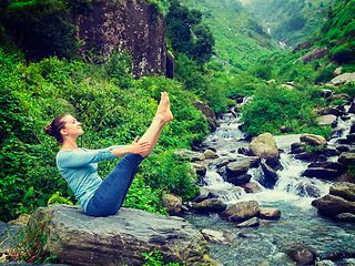 Image showing Woman doing Ashtanga Vinyasa Yoga asana Navasana - boat pose