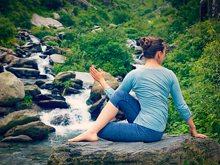 Image showing Woman doing Ardha matsyendrasana asana outdoors