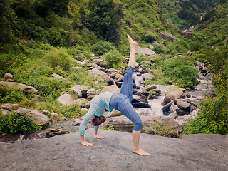 Image showing Woman doing yoga asana at waterfall