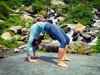 Image showing Woman doing Ashtanga Vinyasa Yoga asana Urdhva Dhanurasana - up