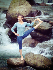 Image showing Woman doing Ashtanga Vinyasa Yoga asana outdoors at waterfall