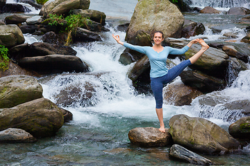 Image showing Woman doing Ashtanga Vinyasa Yoga asana outdoors at waterfall