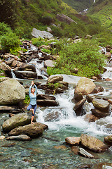 Image showing Woman in yoga asana Vrikshasana tree pose at waterfall outdoors