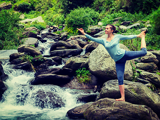 Image showing Woman doing yoga asana Natarajasana outdoors at waterfall