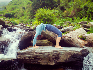 Image showing Woman doing Ashtanga Vinyasa Yoga asana Urdhva Dhanurasana - up