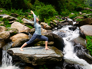 Image showing Woman doing Ashtanga Vinyasa Yoga asana Virabhadrasana 1 Warrior