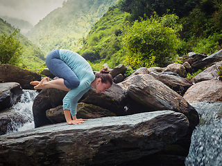 Image showing Woman doing Bakasana asana outdoors