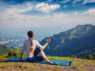 Image showing Woman practices yoga asana outdoors