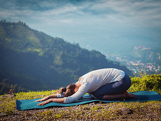 Image showing Sporty fit woman practices yoga asana Balasana