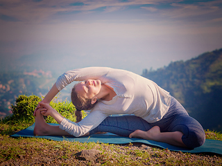 Image showing Young sporty fit woman doing Hatha Yoga asana