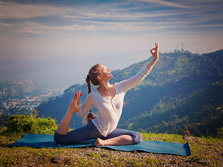 Image showing Sorty fit woman doing yoga asana outdoors in mountains