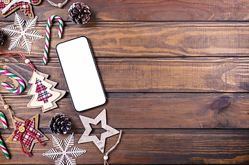 Image showing Smartphone mock up with rustic Christmas decorations