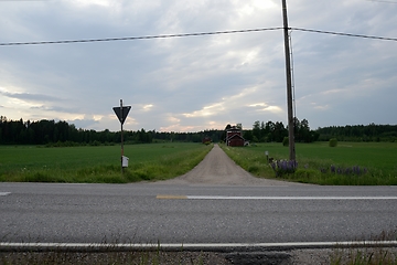 Image showing crossroads of dirt and asphalt roads somewhere in Finland