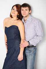 Image showing Young couple hugging on white bakcgroind in studio. Fashion, beauty and advertisement concept. Close up. Copy space for text