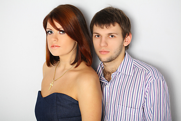 Image showing Young couple hugging on white bakcgroind in studio. Fashion, beauty and advertisement concept. Close up. Copy space for text