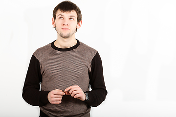 Image showing The romantic young man looking upwards isolated on white background