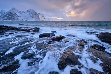 Image showing Coast of Norwegian sea on rocky coast in fjord on sunset