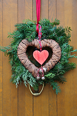 Image showing Traditional christmas wreath on a wooden door