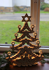 Image showing Illuminated plywood Christmas tree against the window