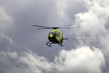 Image showing FinnHEMS Medical Helicopter Against Dramatic Cloudy Sky