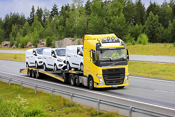 Image showing Yellow Volvo FH Vehicle Carrier Transports New Ford Vans