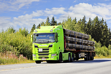 Image showing Lime Green Scania R500 Truck Semi Trailer Hauls Metallic Pipes