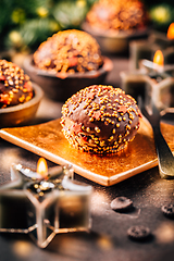 Image showing Small chocolate pastry cakes for Christmas with candles and ornaments