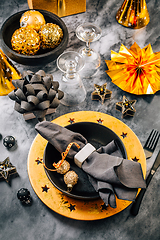 Image showing Glamorous black and gold place setting with modern plates for New Years Eve and Christmas