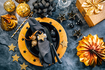 Image showing Glamorous black and gold place setting with modern plates for New Years Eve and Christmas