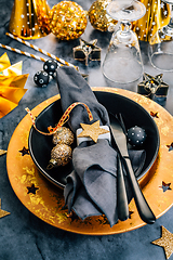 Image showing Glamorous black and gold place setting with modern plates for New Years Eve and Christmas