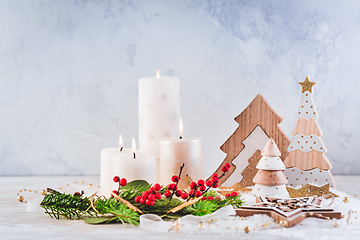 Image showing Christmas decoration with candles and wooden Christmas trees