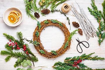 Image showing Steps of making christmas door wreath, top down view of florist's worktable