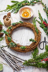 Image showing Steps of making christmas door wreath, top down view of florist's worktable