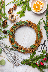 Image showing Steps of making christmas door wreath, top down view of florist's worktable