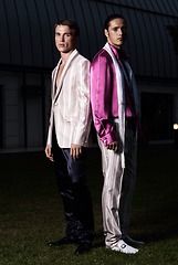 Image showing Fashion portrait of two young sexy handsome men models in casual cloth suit on green grass