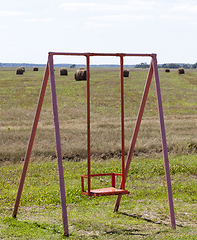 Image showing old swing , field