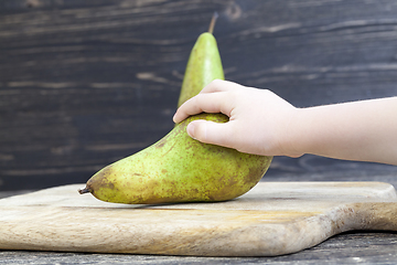 Image showing two old green pears