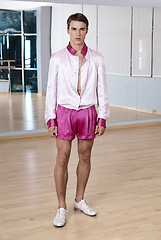 Image showing High fashion young sexy man in pink shorts and a white jacket.