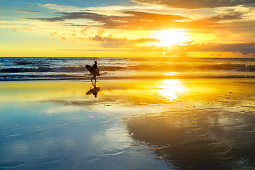 Image showing surfer on beach at susnet
