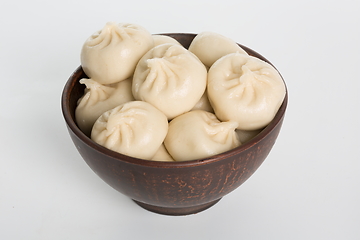 Image showing Georgian dumplings Khinkali with meat on metal plate close-up