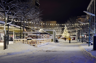 Image showing christmas lights and christmas tree in the snowy town 