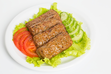 Image showing Three fried breaded cutlet with lettuce, tomatoes and cucumbers on white background