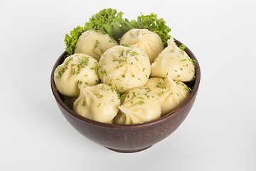 Image showing Georgian dumplings Khinkali with meat on metal plate close-up