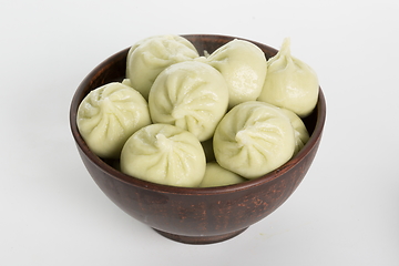 Image showing Georgian dumplings Khinkali with meat on metal plate close-up