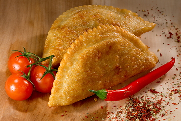 Image showing Cheburek - fried pie with meat and onions. Traditional dish of many turkic and mongolian peoples. Tomato juice.