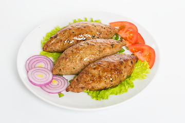 Image showing Three fried breaded cutlet with lettuce, tomatoes, cucumbers and onion on white background