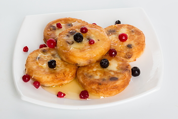 Image showing Cottage cheese pancakes. homemade traditional Ukrainian dish syrniki with honey and sour cream.