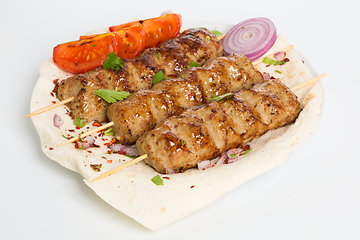 Image showing Lulya kebab from meat on a white plate and wooden board with dill.