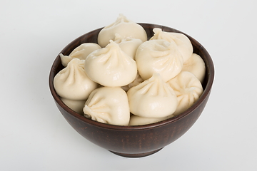 Image showing Georgian dumplings Khinkali with meat on metal plate close-up